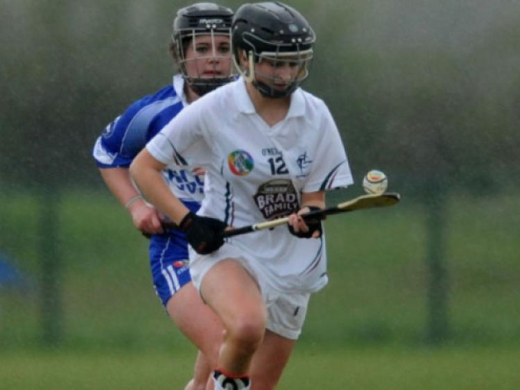 03-05-2013   Kildare's Louise Qualter puts the ball wide after getting past Maeve Collier of Laois in the All Ireland Minor C camogie semi final at Hawkfield.Picture: Adrian Melia