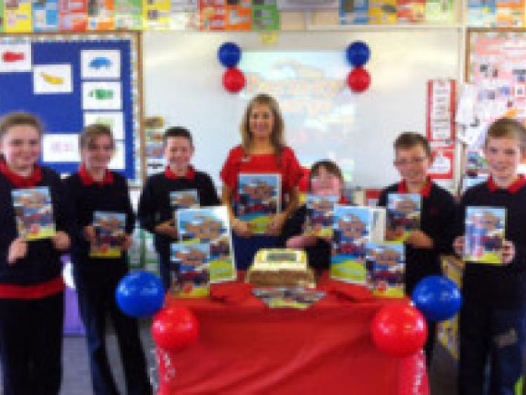 Teacher Grainne O' Shea with some of her students at her book launch