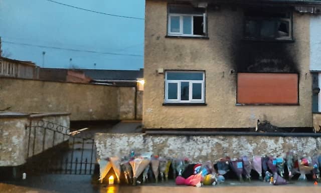 Flowers outside the house which was firebombed resulting in two deaths