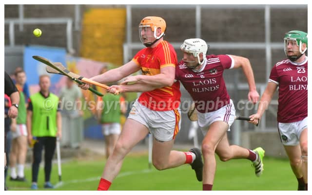 Cathal Murphy, The Harps and Gearoid Lynch, Ballinakill compete for this sliotar