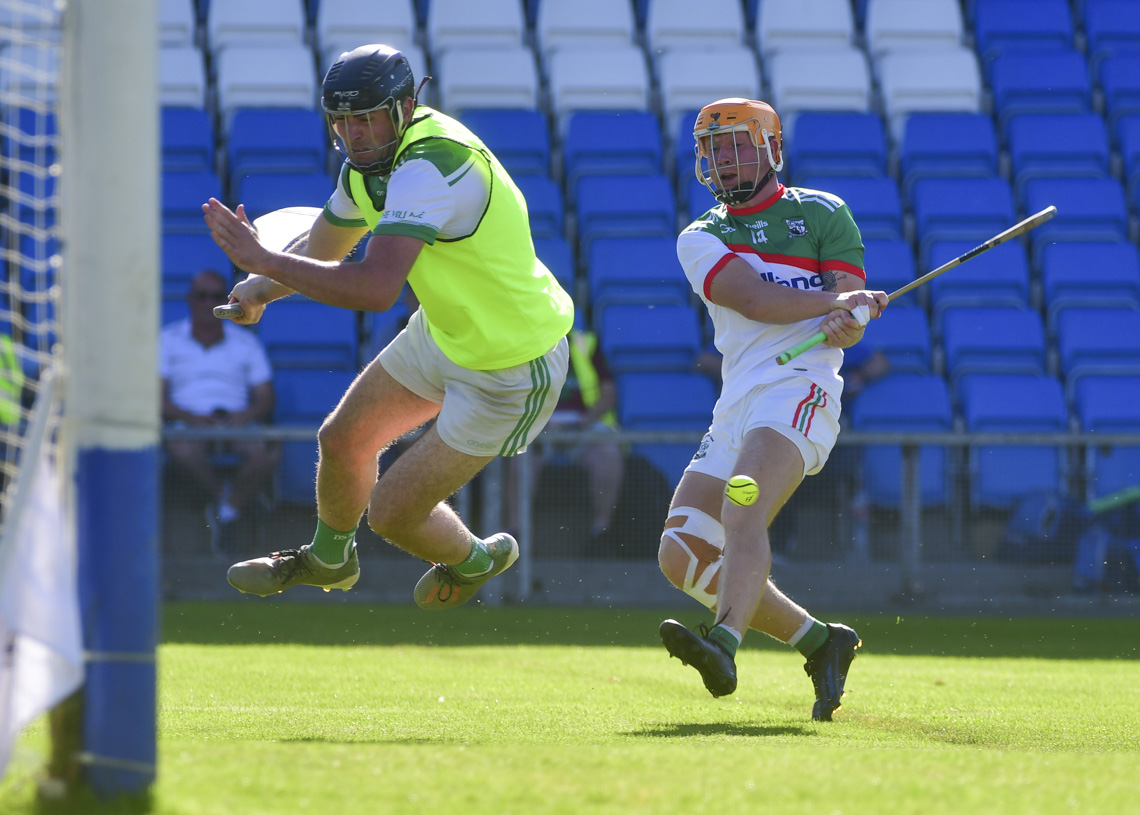 Stephen Kelly, Rosenallis bravely saves Mark Kavanagh, Rathdowney Errill   Photos: Denis Byrne