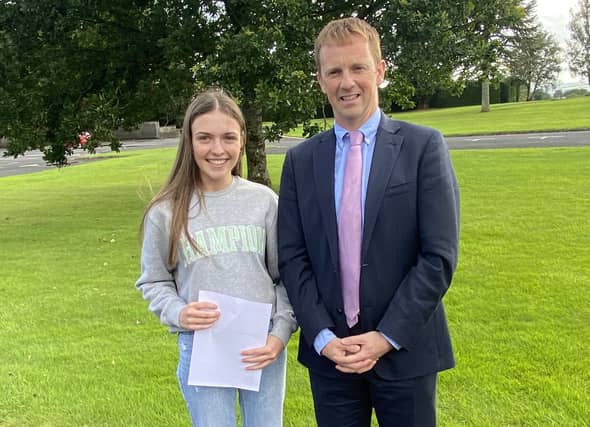 Emma Carney celebrates top marks in her Leaving Cert with Heywood Community School Principal Eamon Jackman.