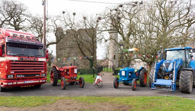 Trucks and vintage tractors pose at Timahoe Round Tower
