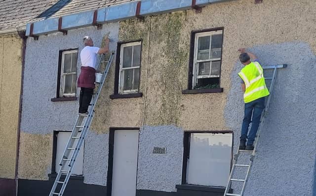A vacant house in Mountmellick getting a cleanup by Tidy Town volunteers.