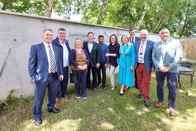 Below: The Minister with new tenants and Laois officials in the garden of one of the houses at Doirin Alainn, Ballylinan.