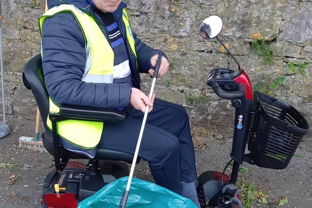 Nuala worked tirelessly weeding along the bridge (pictured above) while Niall Fingleton (below) collected rubbish along the streets.