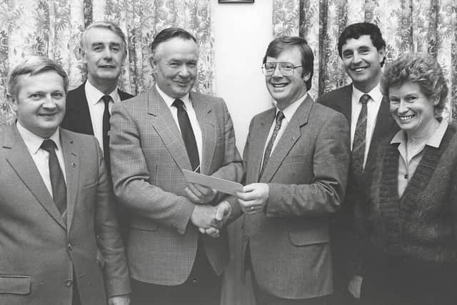 Below: Cormac Lally, President of Abbeyleix CYMS accepting a donation on its behalf following an open day at Abbeyleix Gardens organised by Portlaoise Lions Club in the 1990s.