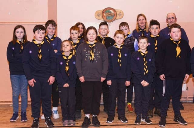 The investiture ceremony involves the cubs or scouts placing their left hand on the scout's flag and saying the Scout's promise, they then make the scouts salute and scouts handshake (left handshake) with the member investing them and the neckerchief is put on them. MORE BELOW PICTURE.