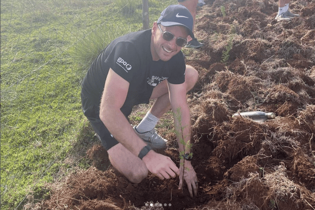 Below: Kieran planting trees.