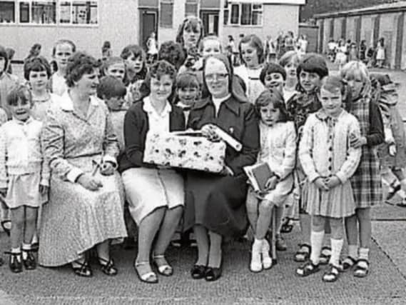 Sr. Paula receives a presentation on the occasion of her retirement from Sacred Heart School from teachers and pupils.