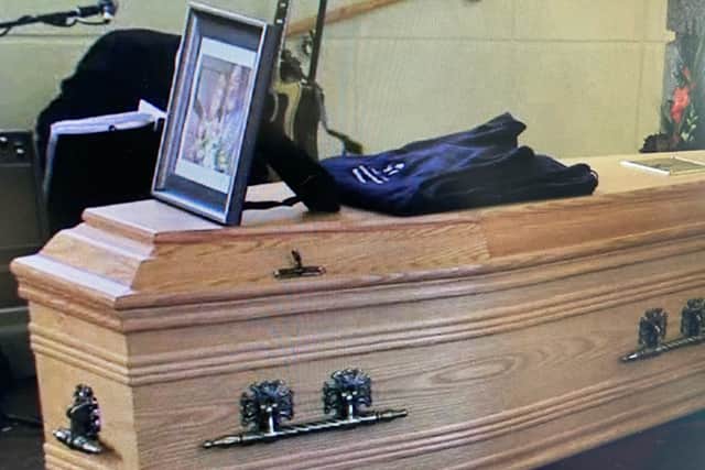 Below: the couple's photograph placed on the coffin along with a jacket with the Mountmellick Credit Union logo.
