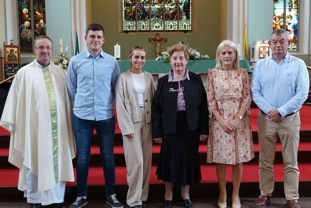 Below: Fr Joe O'Neill with Seamus Bennett and family after the Mass at St Michael's church, Portarlington. Photos: Michael Scully.