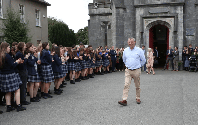 Colaise Iosagain students form a guard of Honour for retired Principal , Seamus Bennett as he leaves St. Michael's church, Portarlington after a Mass for the school. Photo: Michael Scully.