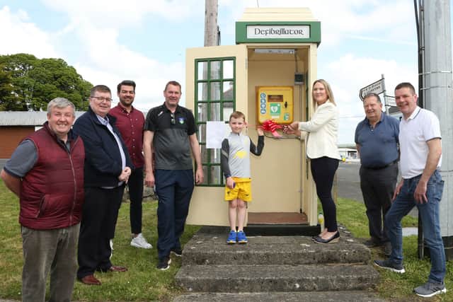 Below: Tim Kearney, Cllr Paschal Mc Evoy, James Hyland (The Coffee Shop), Dan O'Neill, Scott Courtney holding the ribbon which his mother Sally Courtney (Chairperson, Ballybrittas Tidy Towns) cut for the new Defibrillator launch, Fergus O'Reilly and Adrian O'Halloran. Photo: Michaell Scully