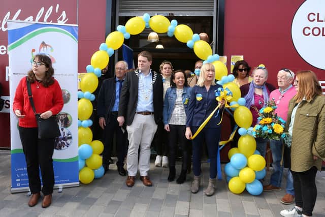 Below: Polena (left) intrepreting to Ukraine people at the opening of the Zero Cost Shop in Portlaoise. Photo: Michael Scully