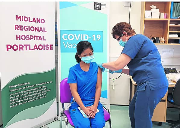 Aidel Aurel Casabar, staff nurse ED, is the first person in the Midland Regional Hospital Portlaoise to be vaccinated. She was vaccinated by Mary Gilligan, Clinical Placement Co-ordinator.