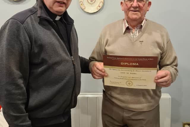 Below: Fr Murphy presenting Leon de Barra with his diploma and medal.