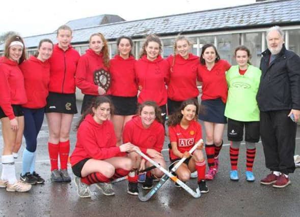 Garry Luttrell pictured with a squad of hockey players from Abbeyleix Hockey club