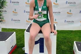 Ava O'Connor with her parents Sinead and Liam after winning gold. Photo credit: Tullamore Harriers Facebook