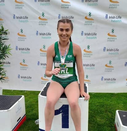 Ava O'Connor with her parents Sinead and Liam after winning gold. Photo credit: Tullamore Harriers Facebook
