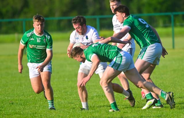 Robbie O'Flynn and Eoin Buggie compete for possession in Tuesday evening's game