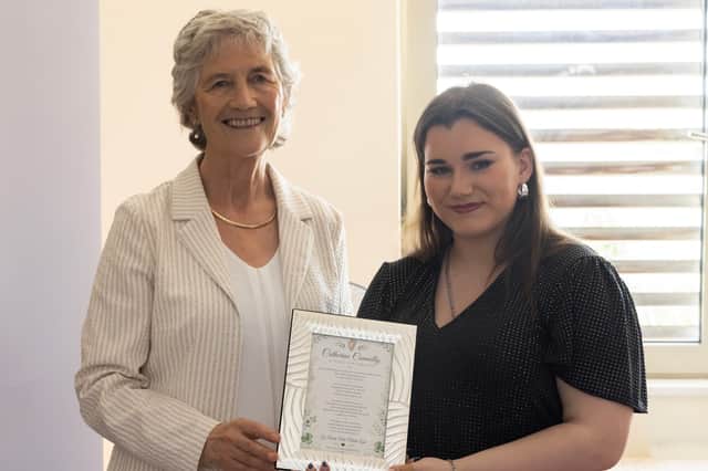 Poet Leah O'Reilly Redmond presents a copy of her poem, Catherine Connolly – A Voice for Ireland to the President.