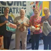 Mrs Lucy Conroy presents staff at Portlaoise's paediatric unit with knitted and crocheted baby hats and blankets