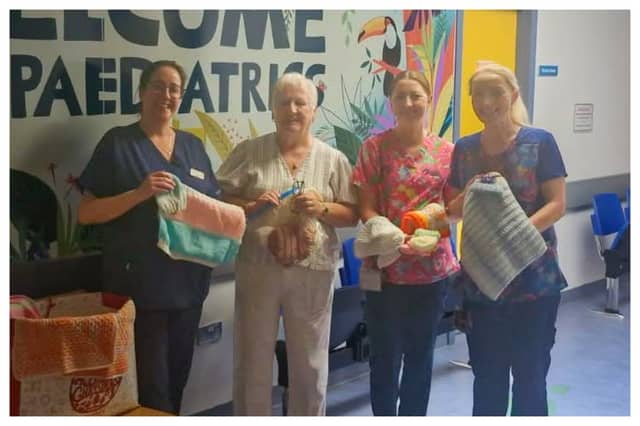 Mrs Lucy Conroy presents staff at Portlaoise's paediatric unit with knitted and crocheted baby hats and blankets