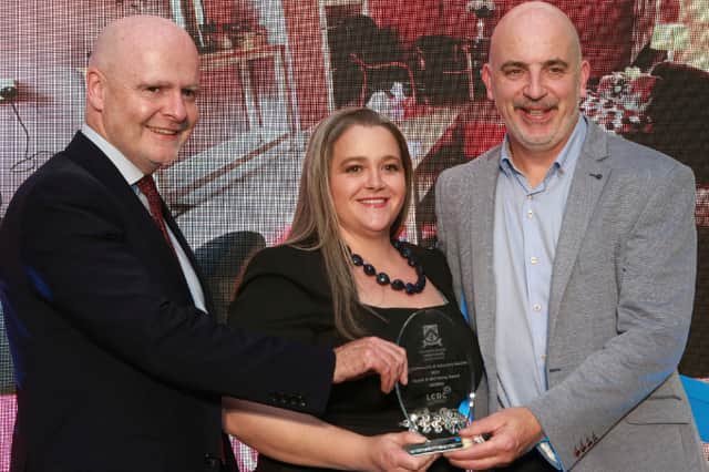 Michael Rainey, Chief Executive LCC ,  presents the Winners  Award in the Health and Wellbeing  Categoryto  SOSAD Laois  members -  Paulline Bell and Ronan Devery  at the 2026 Laois Community & Voluntary Awards .