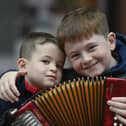 Two young boys with an accordion