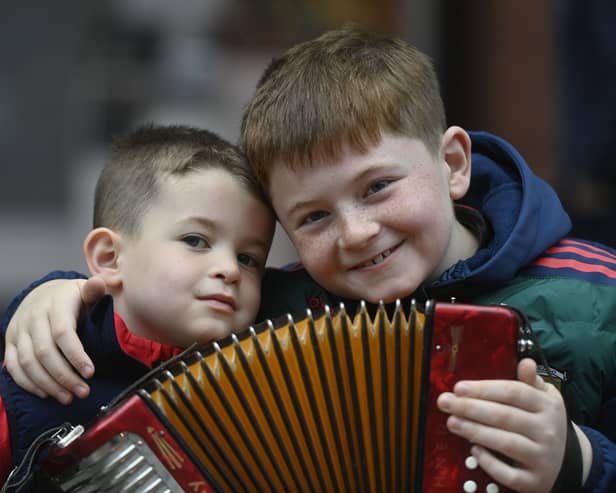 Two young boys with an accordion