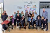 Gerry Kelly (MC), pupils and staff at Kolbe Special School, and Philip Greene (Stradbally Union of Parishes Treasurer) present the €1,500 cheque to Yvonne Hennessey (VP of Kolbe Special School), Annette Jones (Fashion Show Co-ordinator), and Della Dineen (MC) 