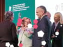 Mary White raises the trophy watched by chair Robbie Quinn, as Abbeyleix Tidy Town wins 2026 Ireland's Tidiest Small Town Award.