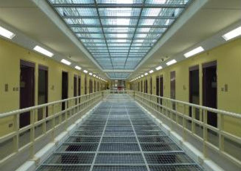 Four charged after prison death