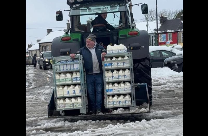 COLD SNAP: Special delivery for shop in snowbound town as milk arrives on back of tractor