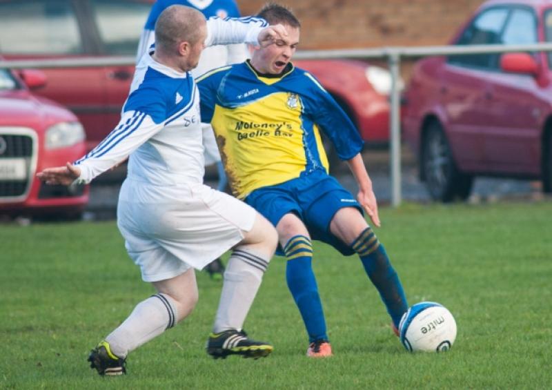 Mountmellicks' Dave Lee about to shoot as O'Moores Cillian Doyle looks to close down. Photo Denis Byrne.
