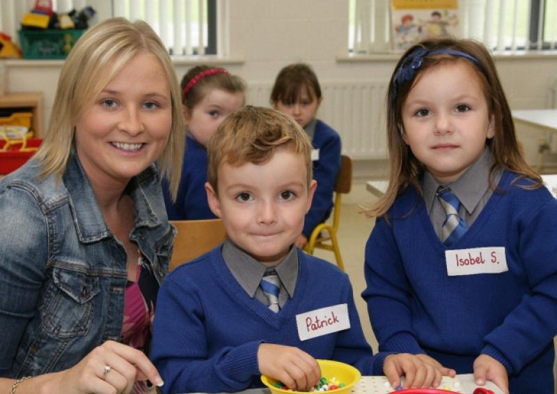 Teacher Ms.Sarah Skehan , with Twins- Patrick and Isobel Scully , on their first day at Scoil Naomh Eoin N.S. Killenard.           Photo: Michael Scully .