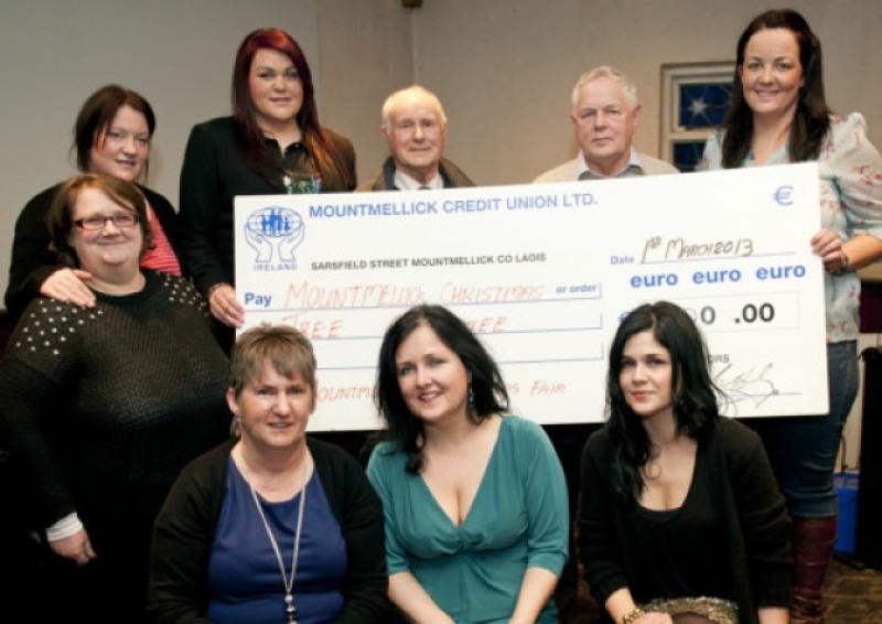 Pictured are members of Mountmellick Christmas Fair Committee presenting a cheque to Brian and Ger Lynch of Mountmellick Christmas Tree Committee. Photo Denis Byrne.