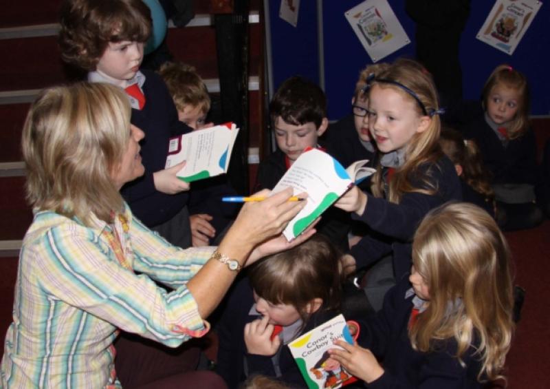 Gillian Perdue signing books at Portlaoise Library for Timahoe NS students