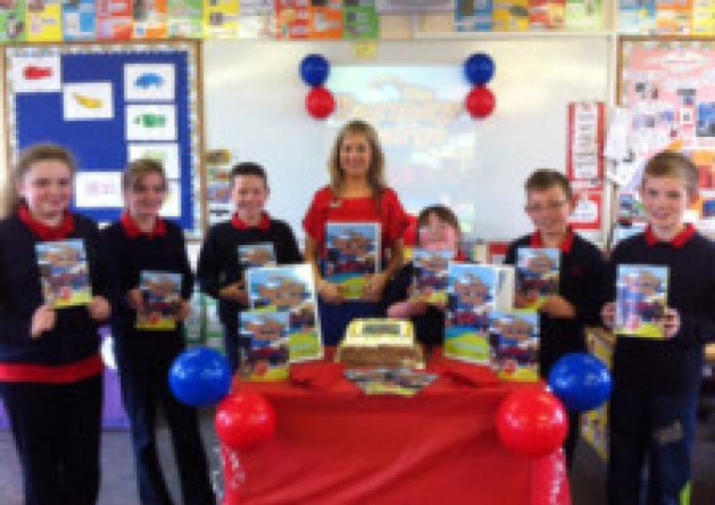 Teacher Grainne O' Shea with some of her students at her book launch