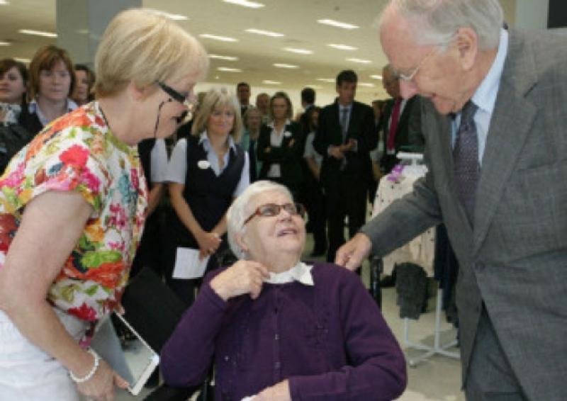 97 Year - old  Mrs. Kathleen Lyons , Ballyroan  - a customer at Shaws Dept. Store , Portlaoise since 1924 - chatting with  Mr. M.V. Shaw ( Former M.D. of Shaws ) at the Official Opening of Shaws new Department Store in Portlaoise , on Thursday last . on left is Geraldine Robbins -Mrs. Lyons daughter .   Photo: Michael Scully - no reproduction fee .