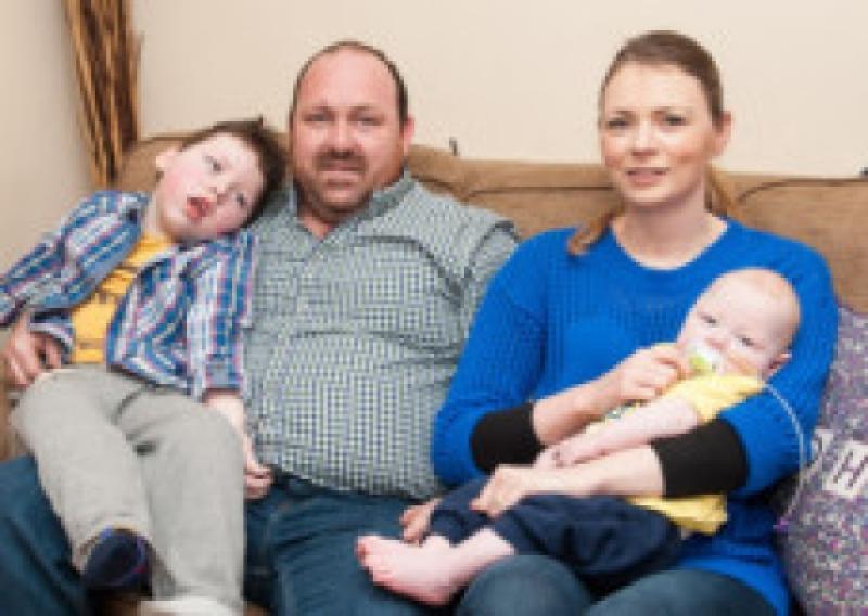 Ben and Jake Connolly with their parents Terence and Nicolette in their home in Mountmellick. Photo Denis Byrne.