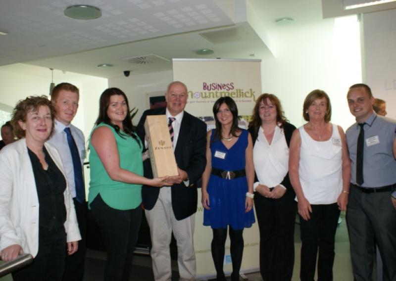 Dragon's Den business mentor Bobby Kerr receiving a presentation from members of Business Mountmellick at the launch of their website www.mountmellick.ie last Tuesday July 8 in the library.