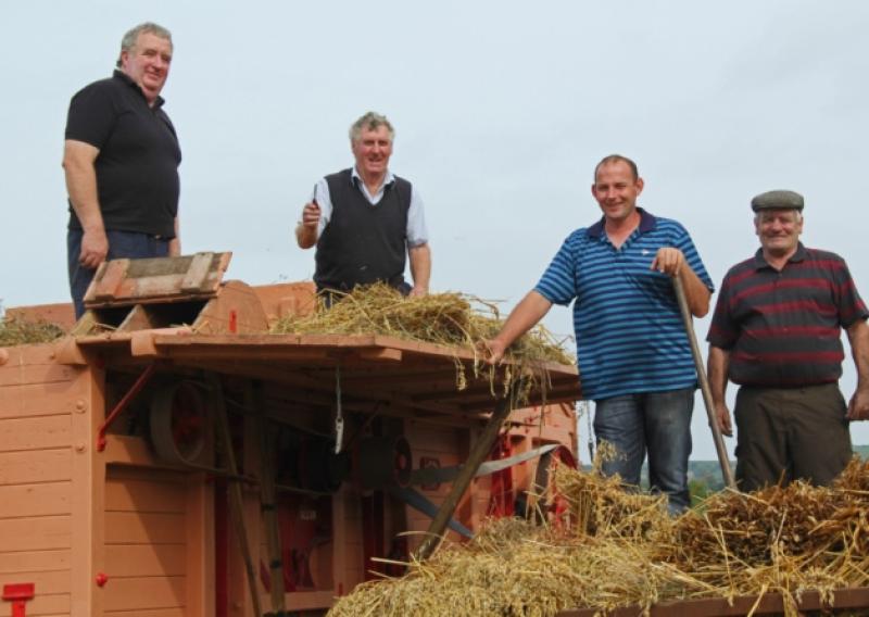 Larry McDonald, Johnny & Padraig Collins and Pat Bowe manning on of three threshing machine at the Knock NA fundraising day in Spink.