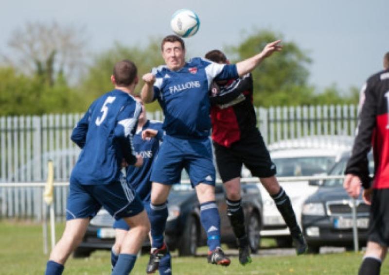 Clonaslee Utds Conor Gorman clears any danger with headed clearance. Photo Denis Byrne.