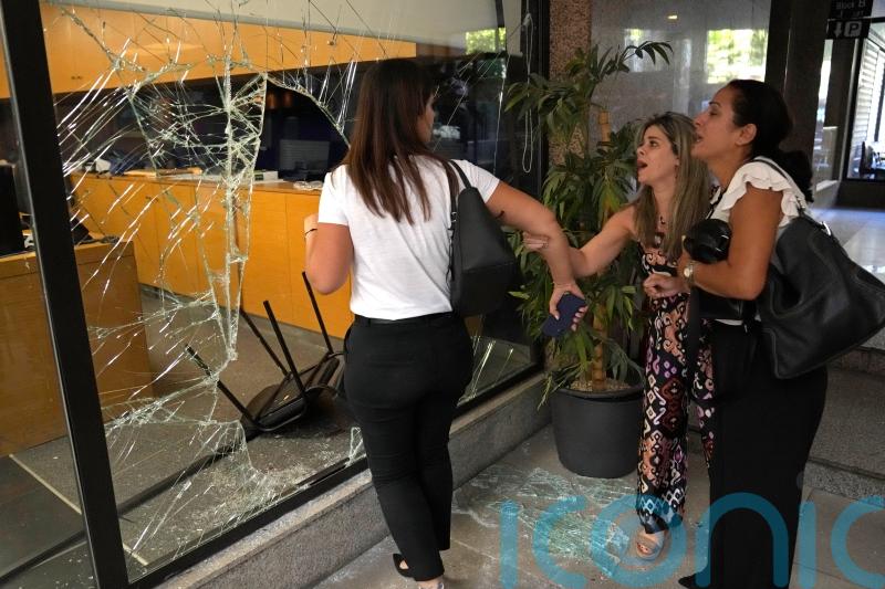 Woman with toy gun takes trapped savings from bank