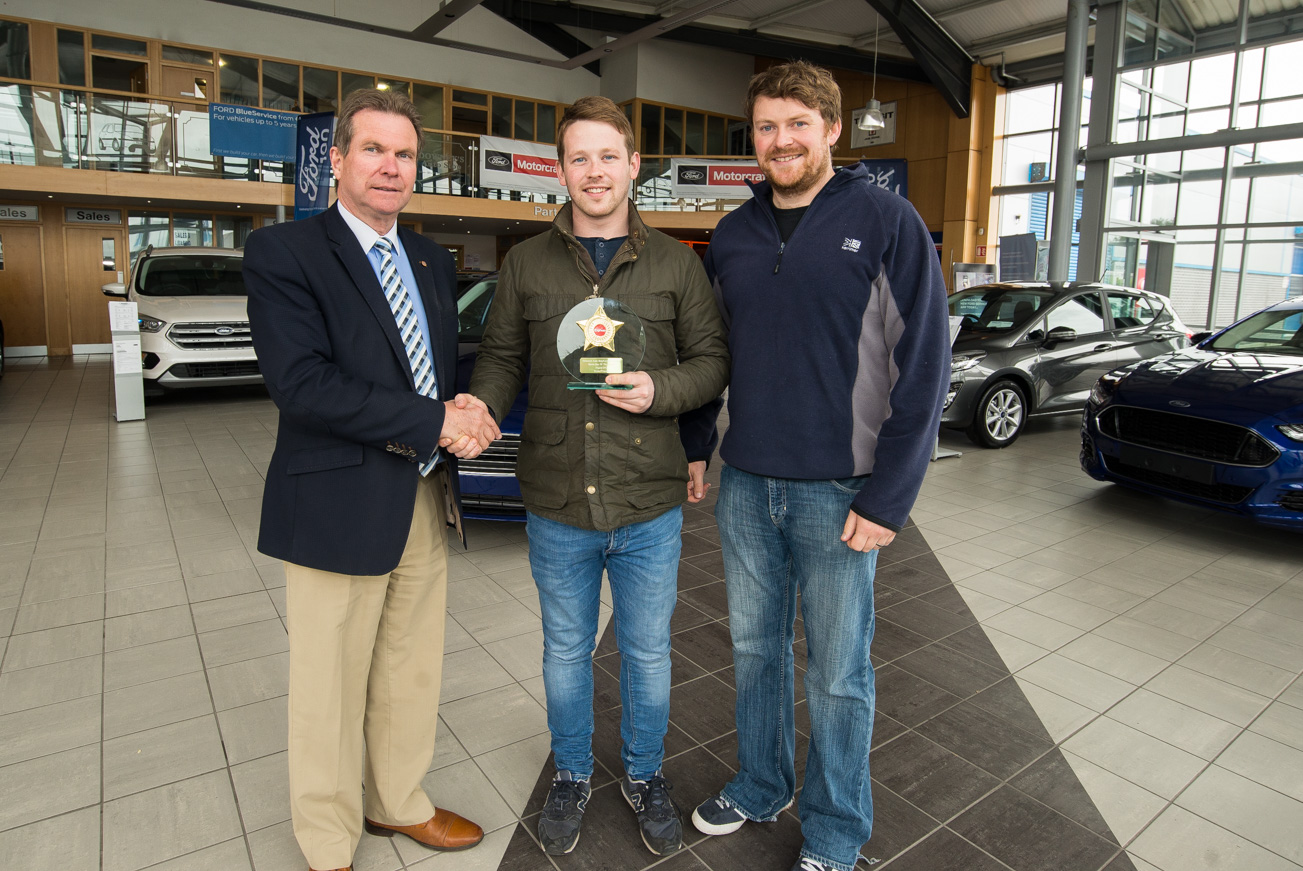 Ruairi O'Connor accepts the award from Richie Downey, Downey's Auto Stop, and Rory Delaney, Leinster Express.